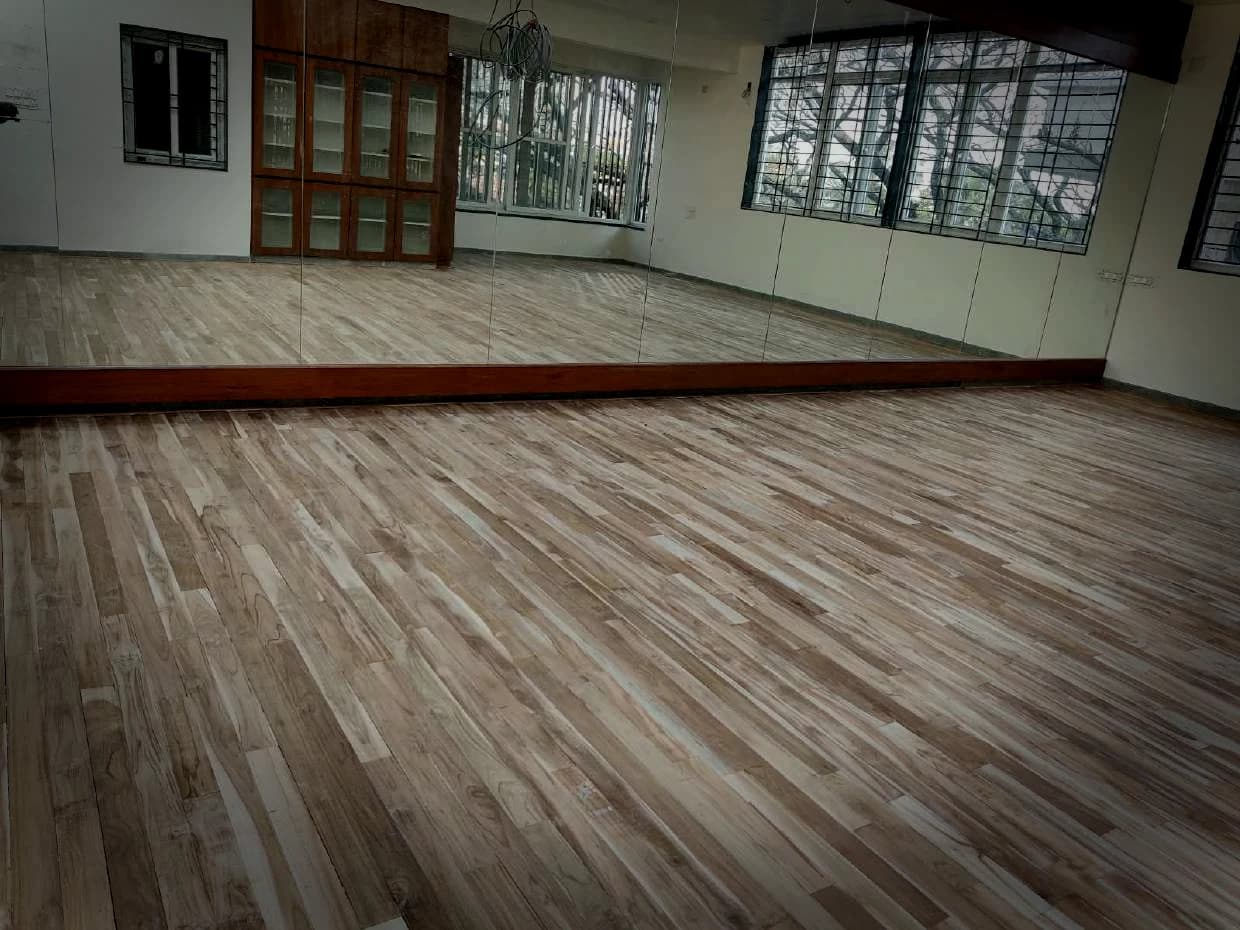 A finished floor under daylight from a full wall of windows