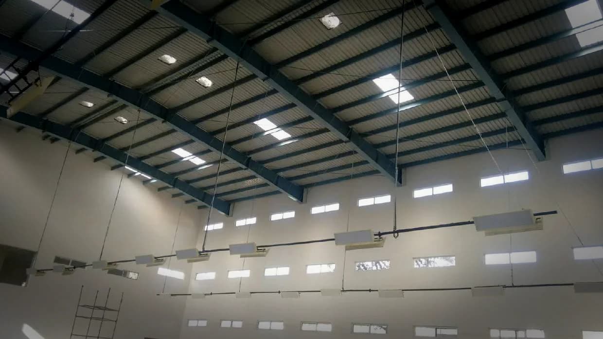 Two fixture rows running the length of a steel-framed hall