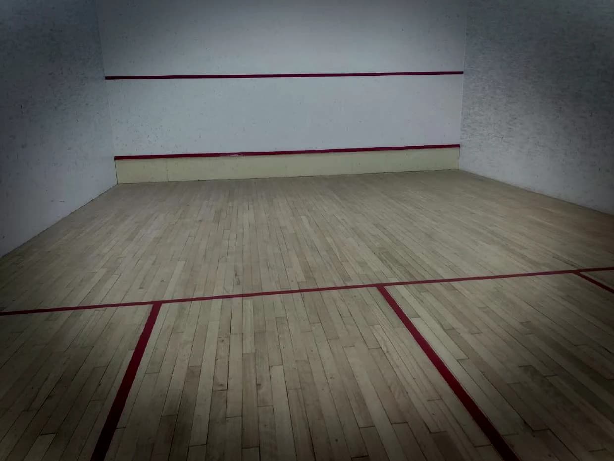 Finished squash court in maple, red lines to the front wall