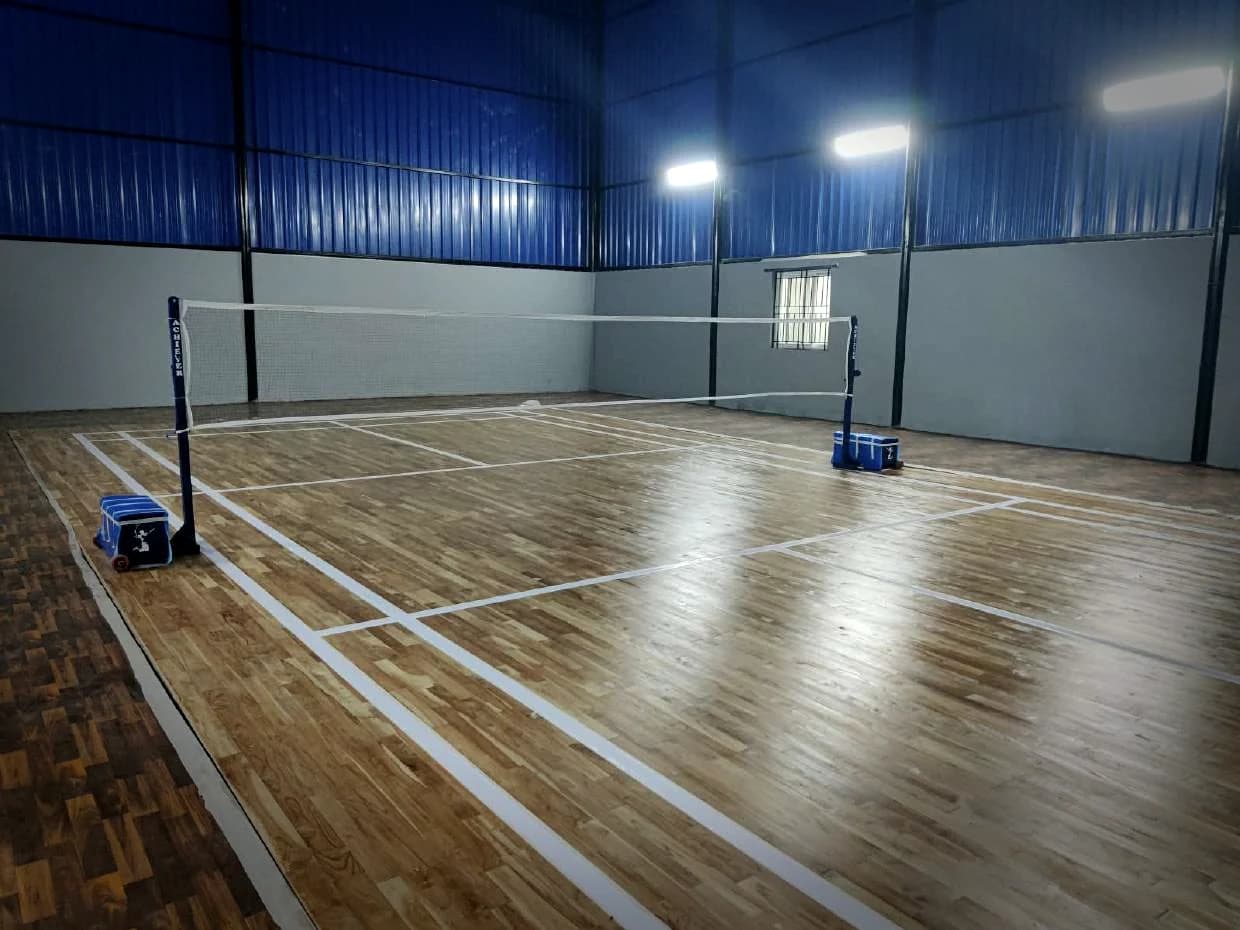 Nets up on a finished court, a blue-clad hall around it