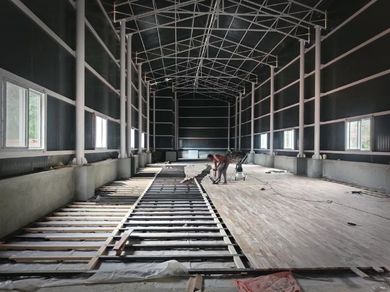 The framework running the length of a hall, boards following behind it