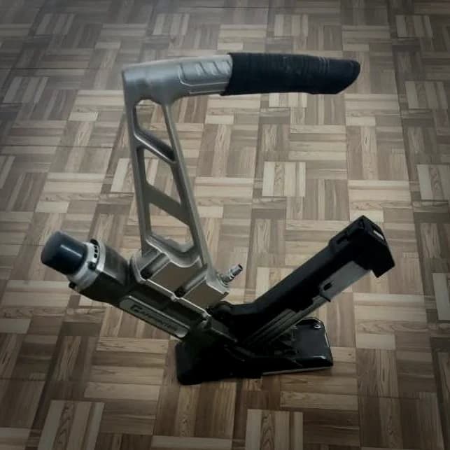 Stand-up hardwood flooring cleat nailer, its angled shoe set to register on a board tongue